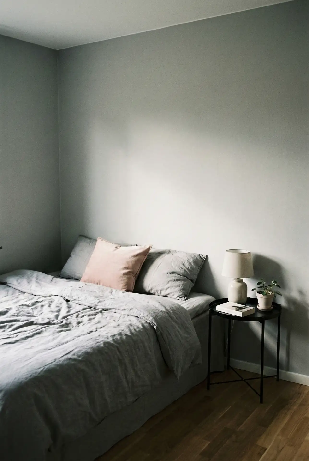 Grey Bedroom With Black Furniture And Soft Pink Art 2