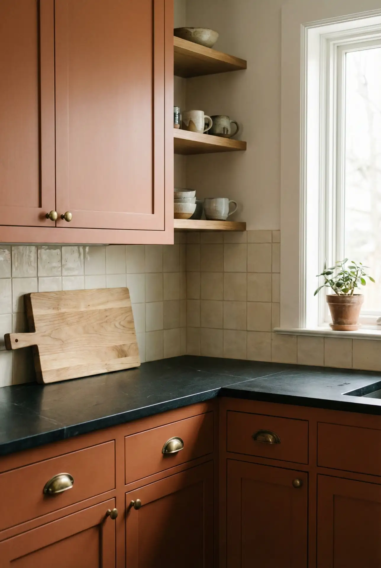 Black Counter Top With Warm Painted Cabinets In Clay Tone 2