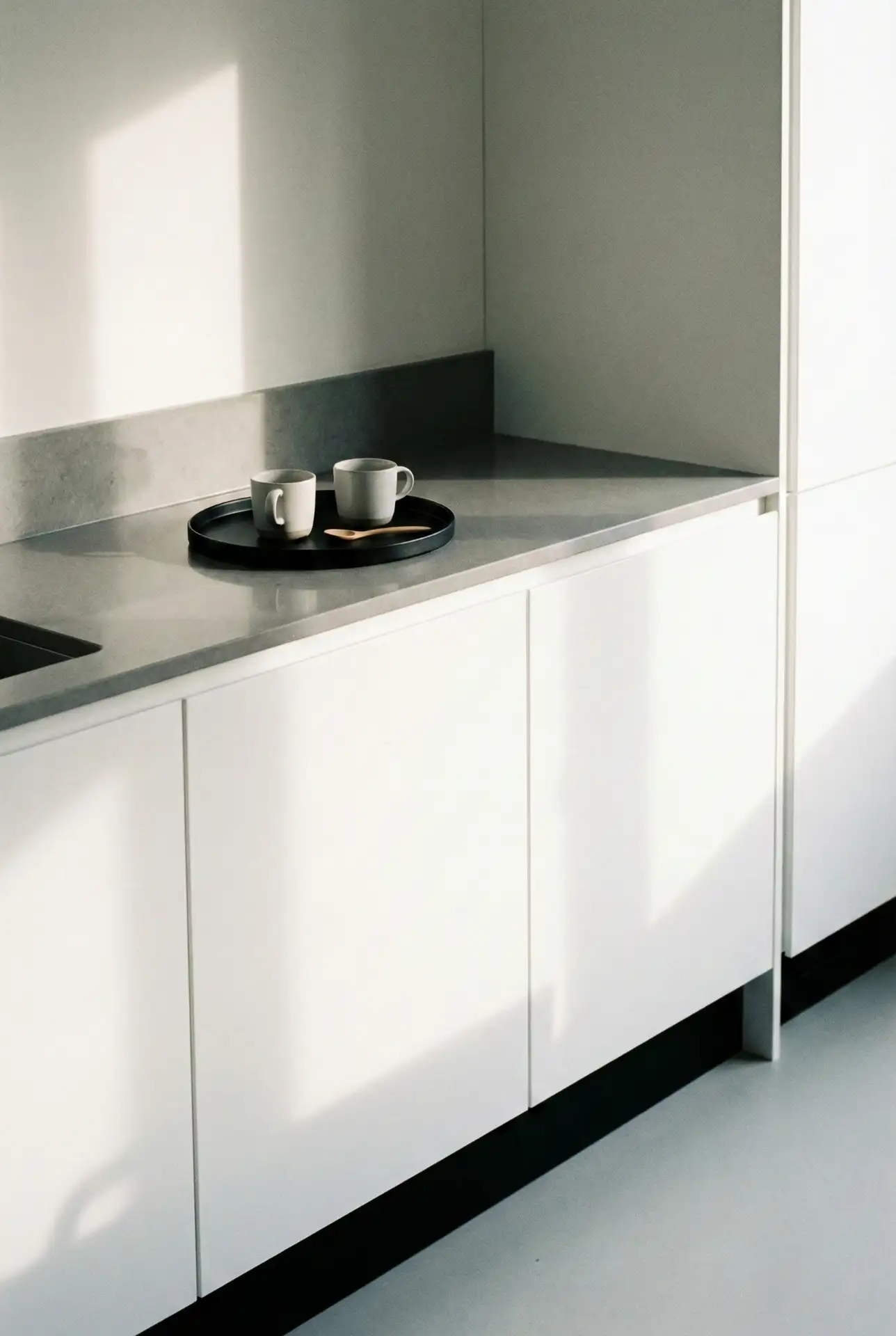 Minimalist Modern Kitchen With Grey Counters And Black Accents 2