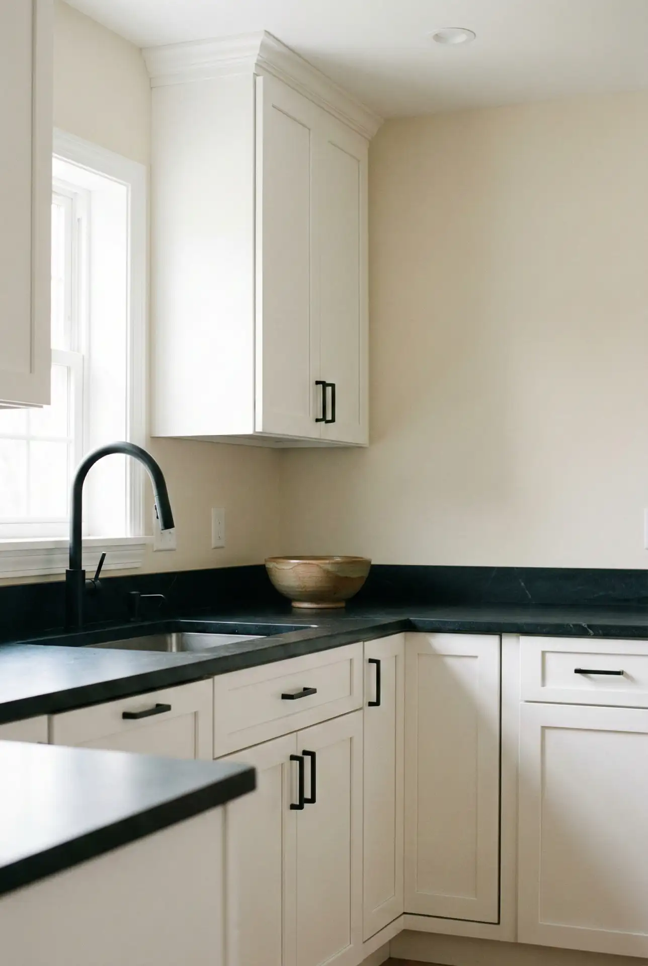 White Cabinets With Black Countertops And Minimal Decor 1