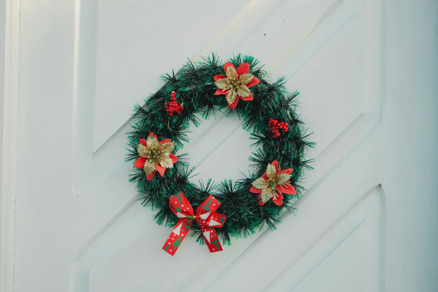 A christmas wreath on a white door