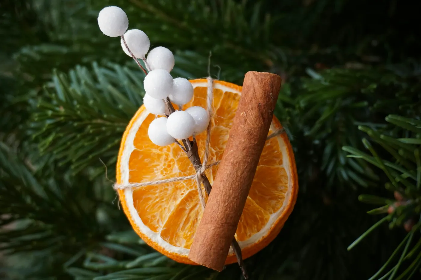 A cinnamon stick and an orange slice on a christmas ornament - Free Photo  on Unsplash