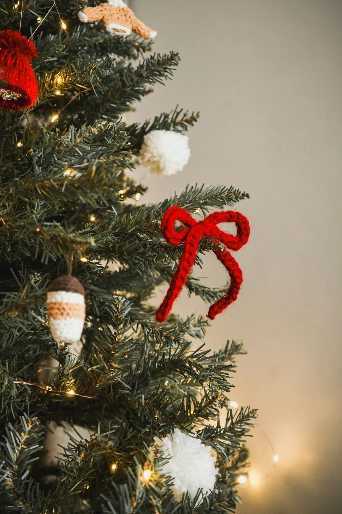 a close-up view of a beautifully decorated Christmas tree featuring handmade crochet and felt ornaments