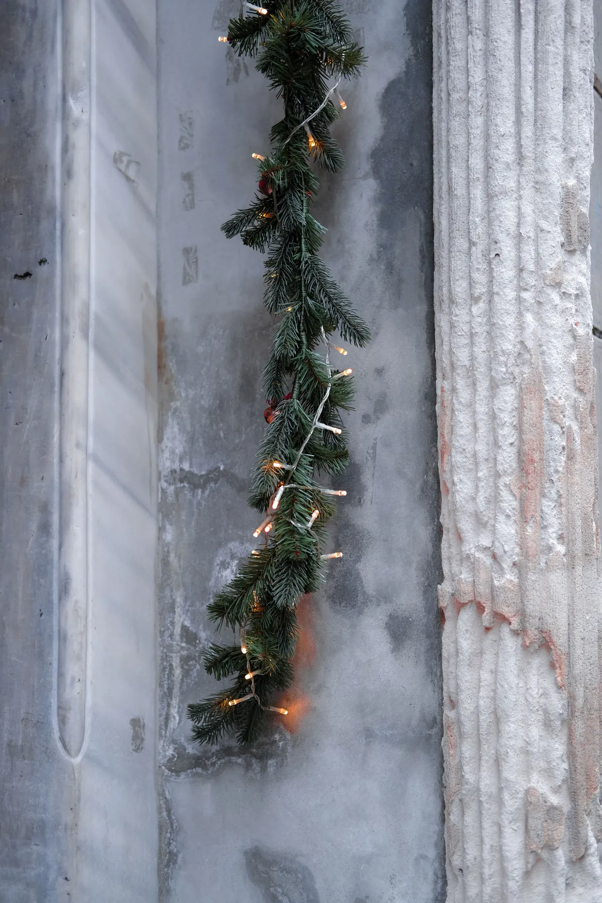 A hanging Christmas garland with lights decorates an ancient wall in İstanbul.