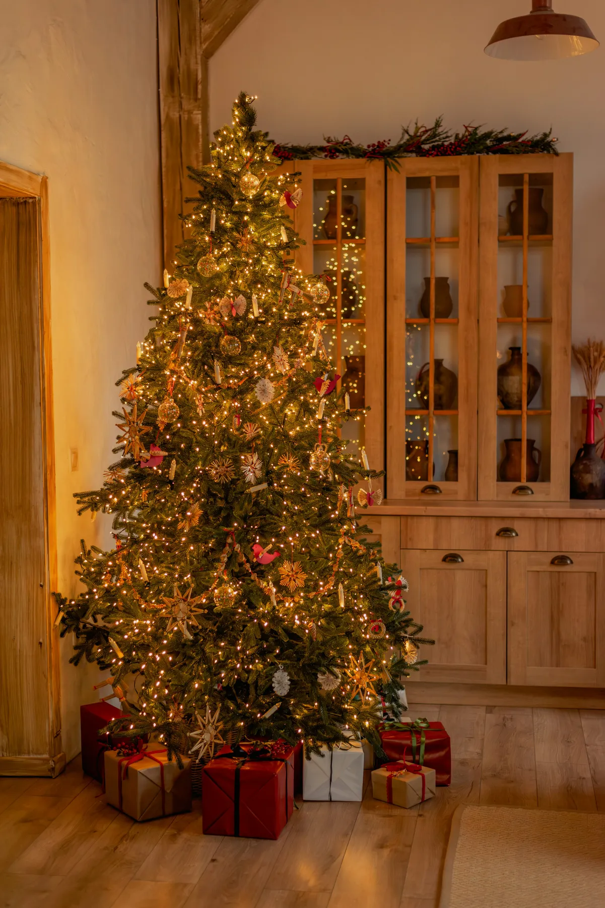 A lit christmas tree in a living room photo – Free Brown Image on Unsplash