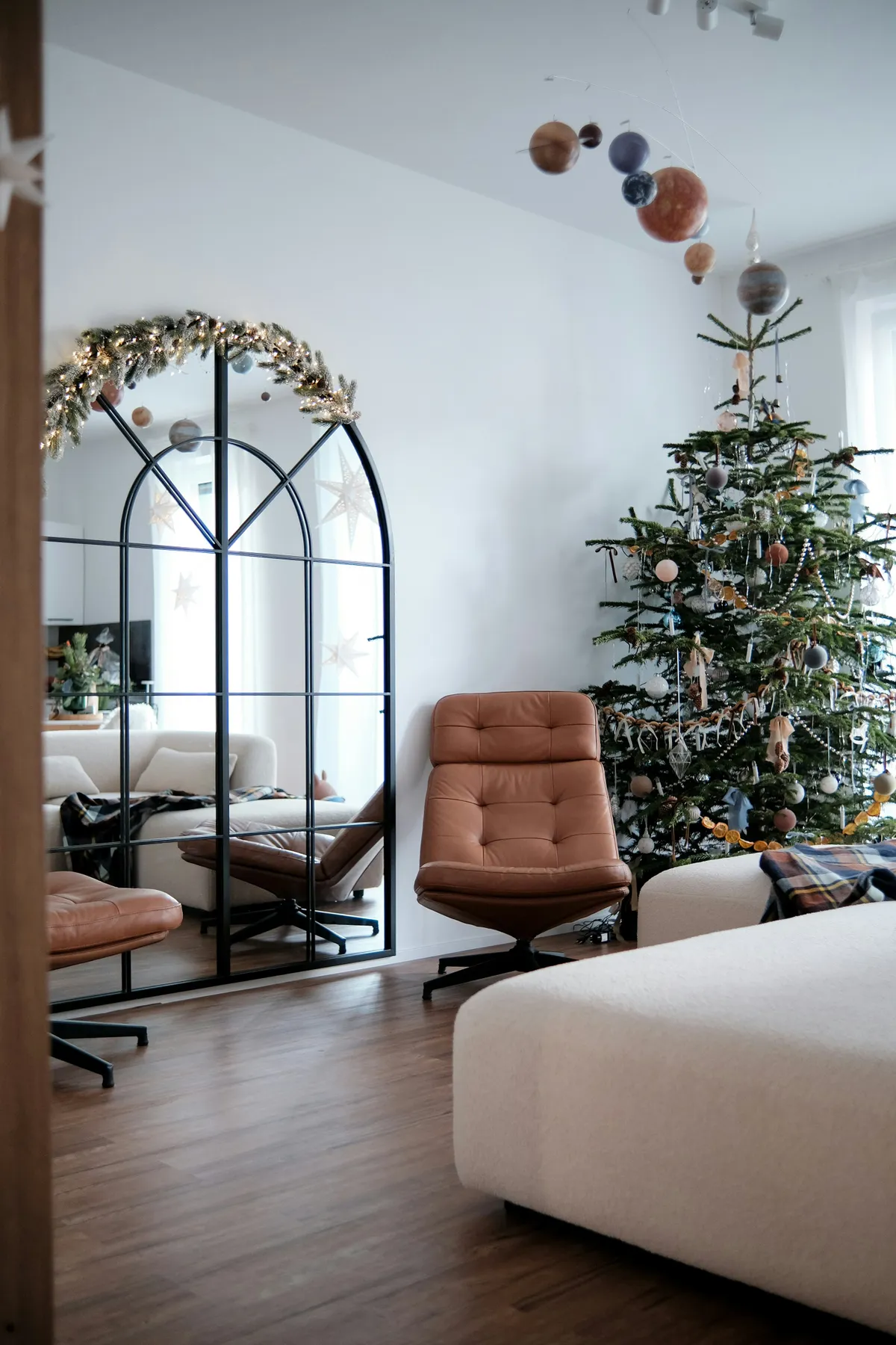 A living room decorated for christmas with a tree