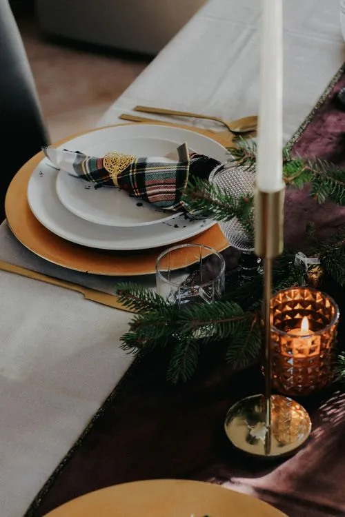 A Table Setting with Christmas Decorations on a Wooden Table · Free Stock  Photo