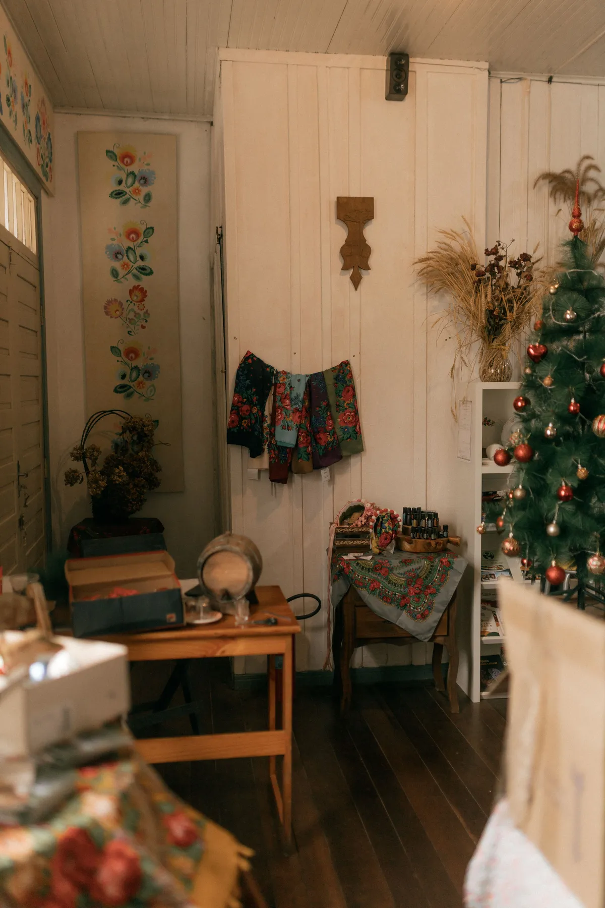 A warm, decorated room with a Christmas tree and vintage furnishings.