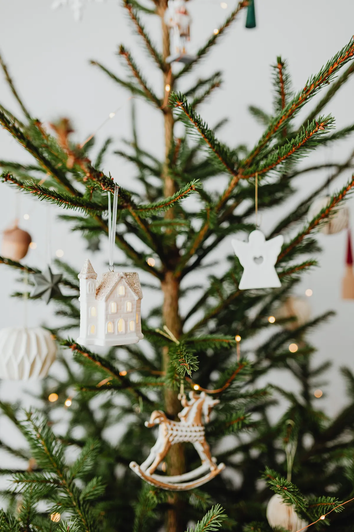 Close-up of a decorated Christmas tree with elegant ornaments and festive lights.