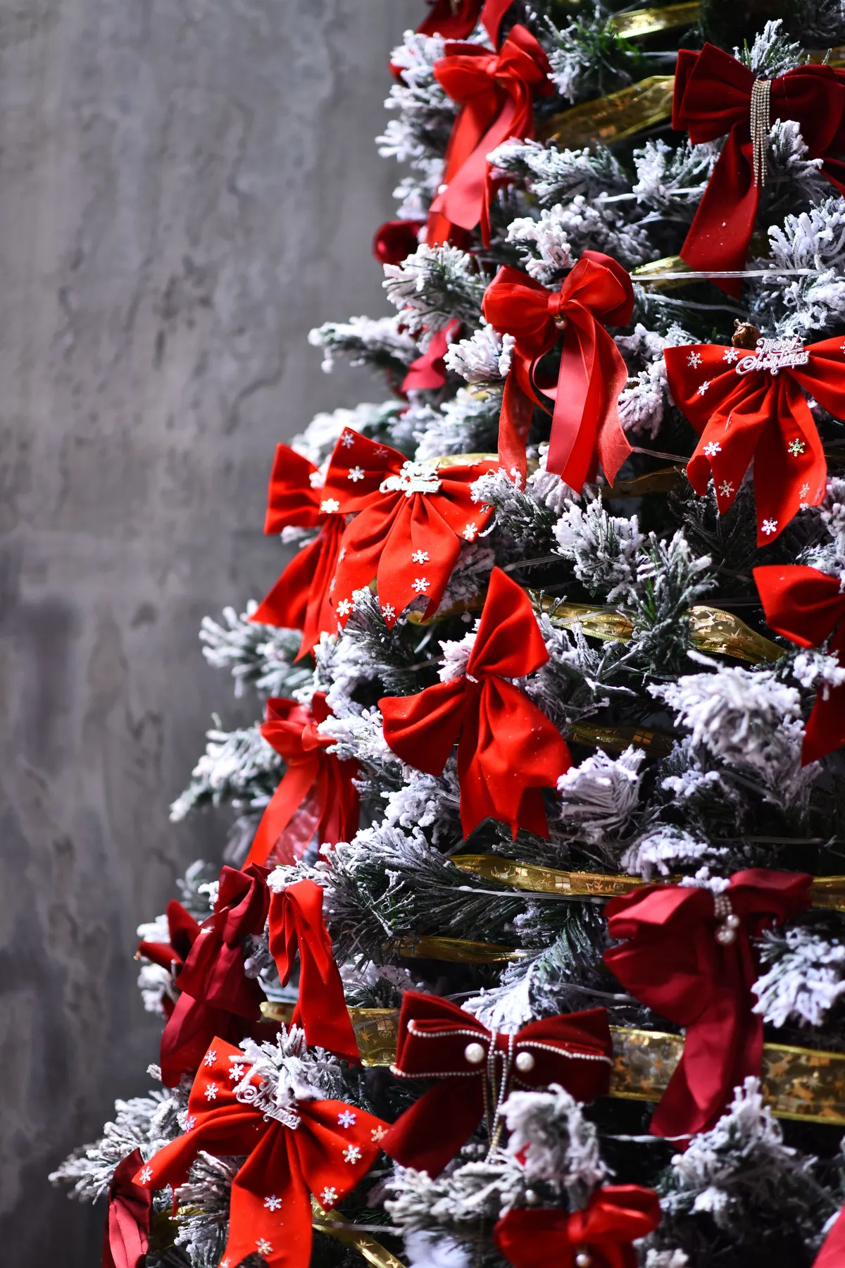 Decorated Christmas tree with red bows and snowflakes, capturing holiday spirit.