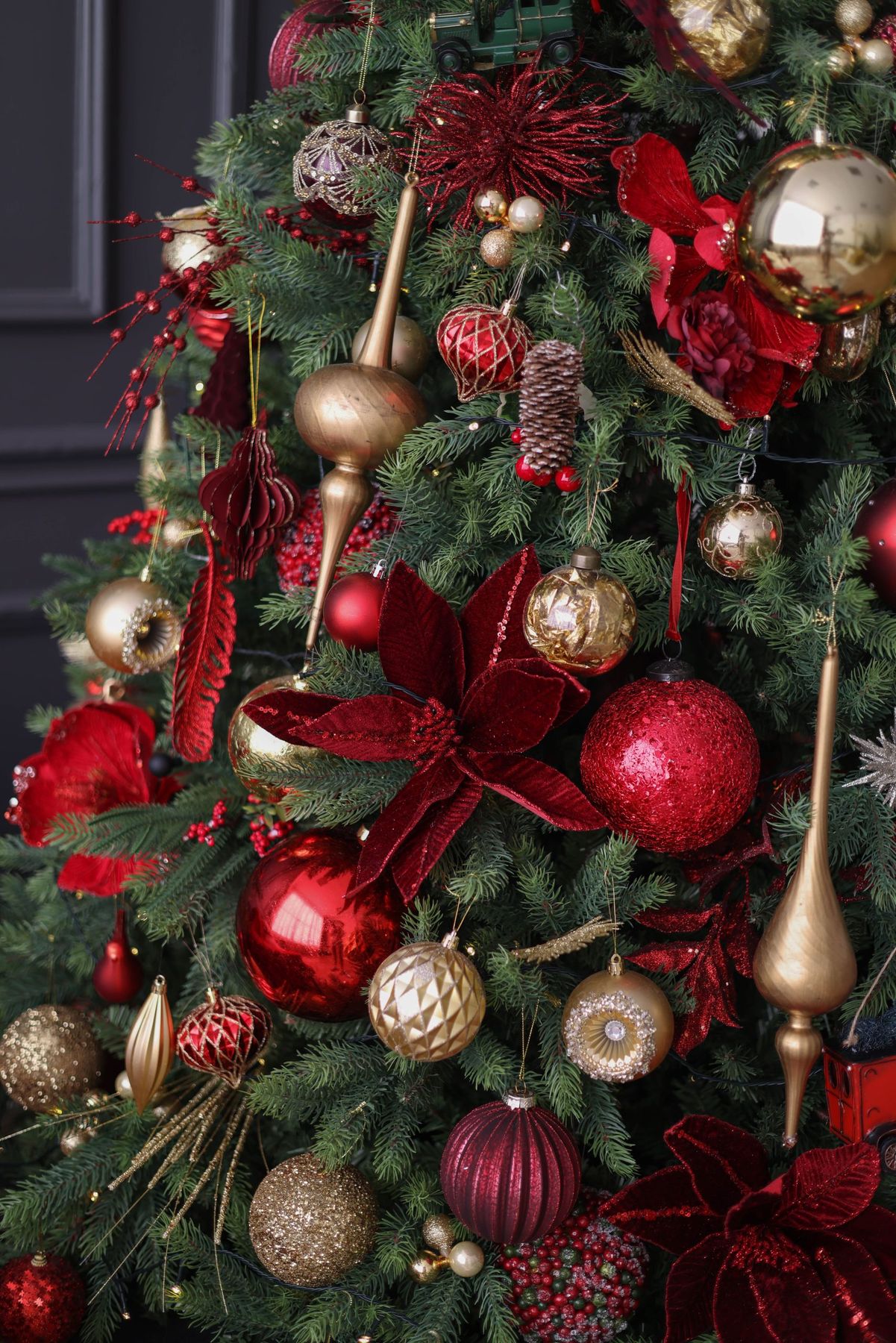 Elegant Christmas tree adorned with red and gold decorations capturing holiday spirit.