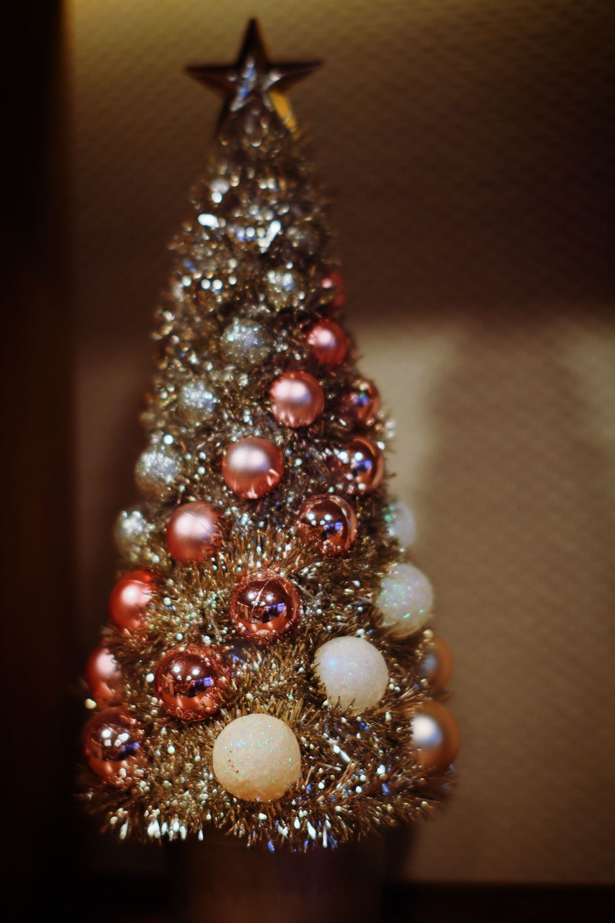 Elegant Christmas tree adorned with shimmering baubles and a star topper.