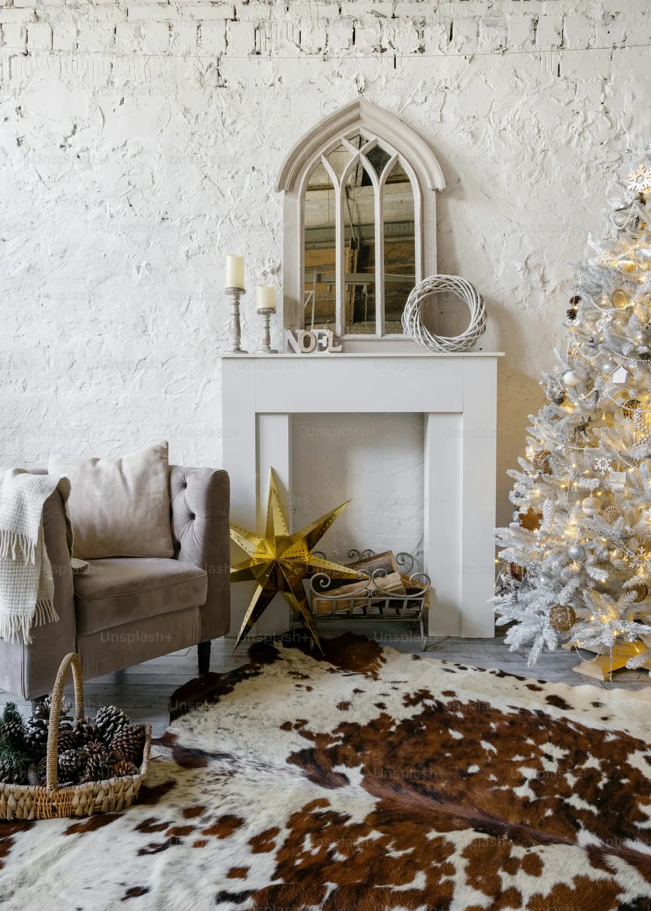 Festive fireplace with white christmas tree - Photo on Unsplash+