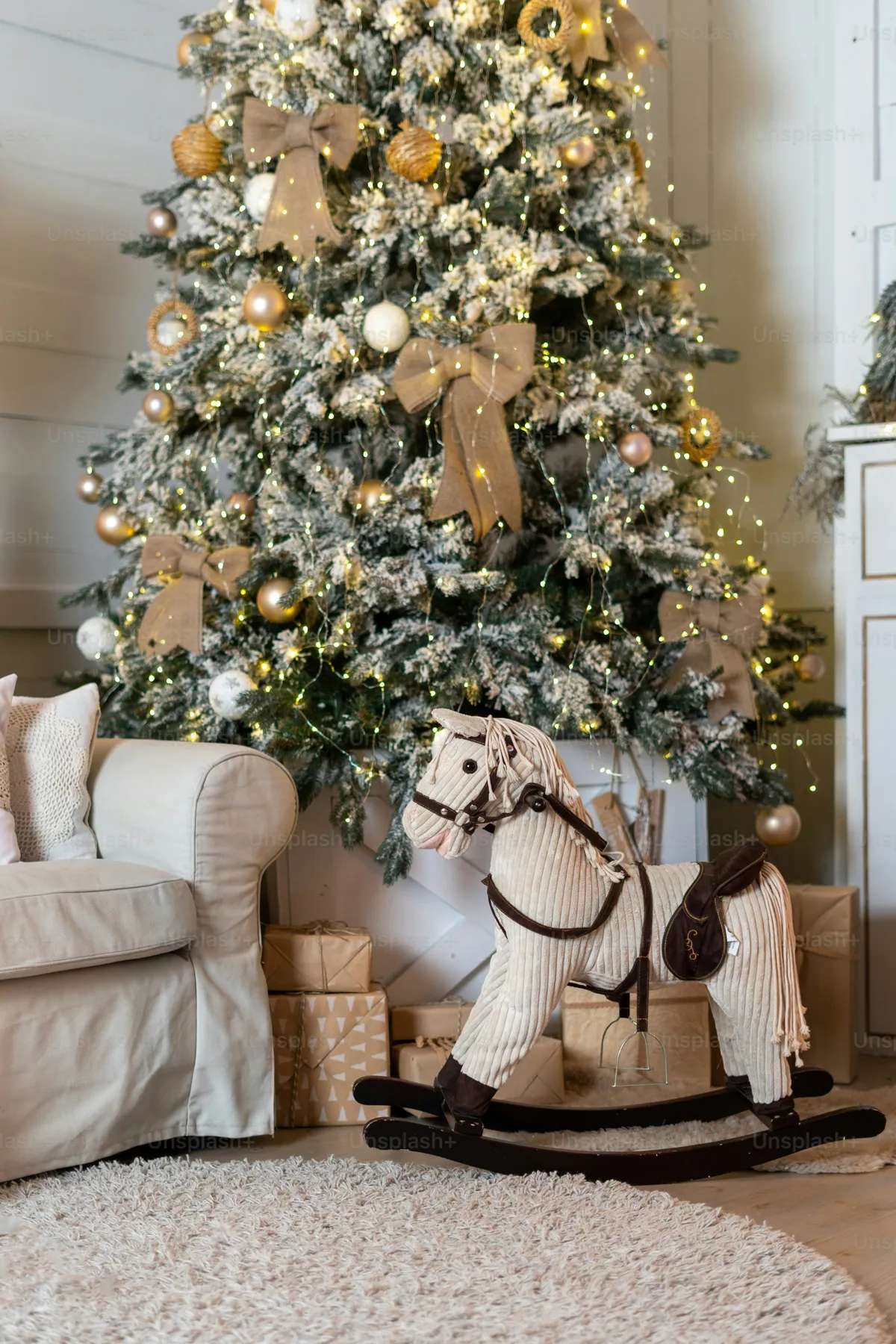 Rocking horse by Christmas tree - Photo on Unsplash+