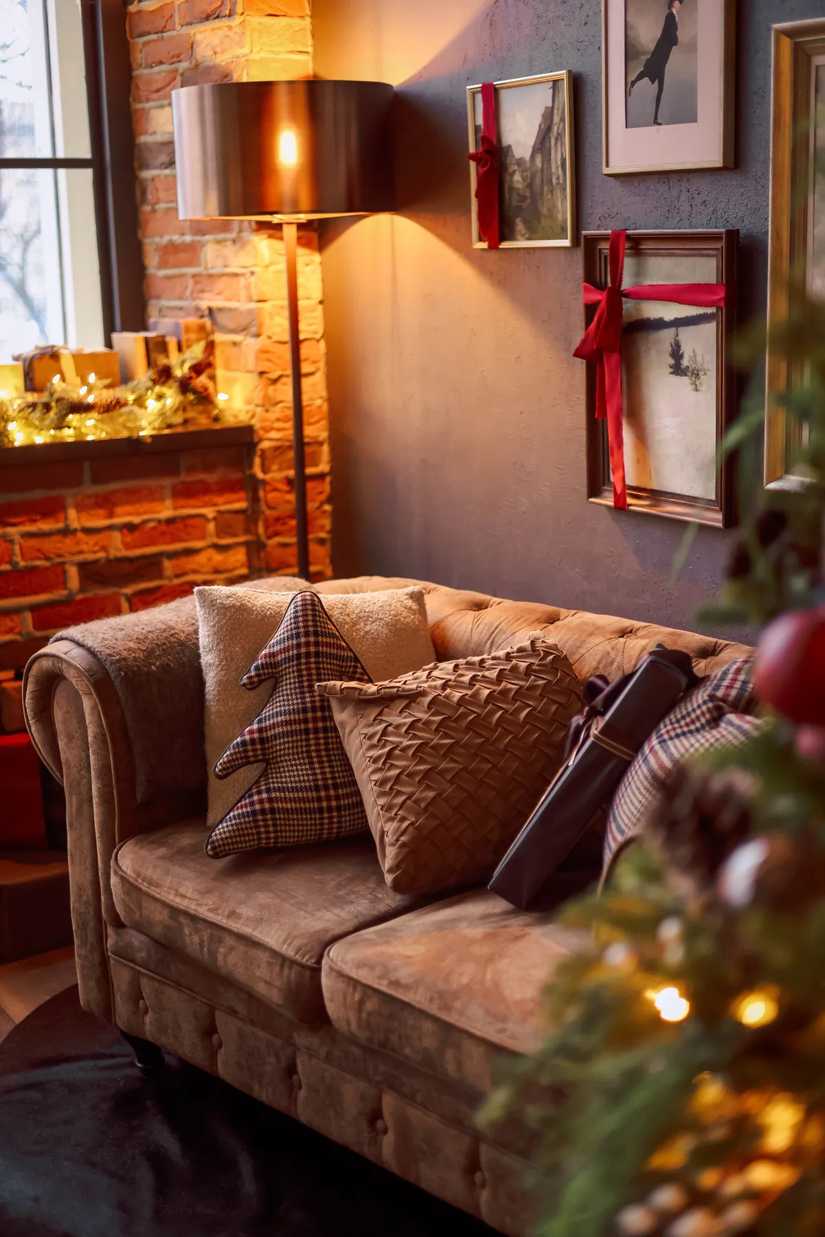 Warm living room with festive decorations and a comfortable sofa.